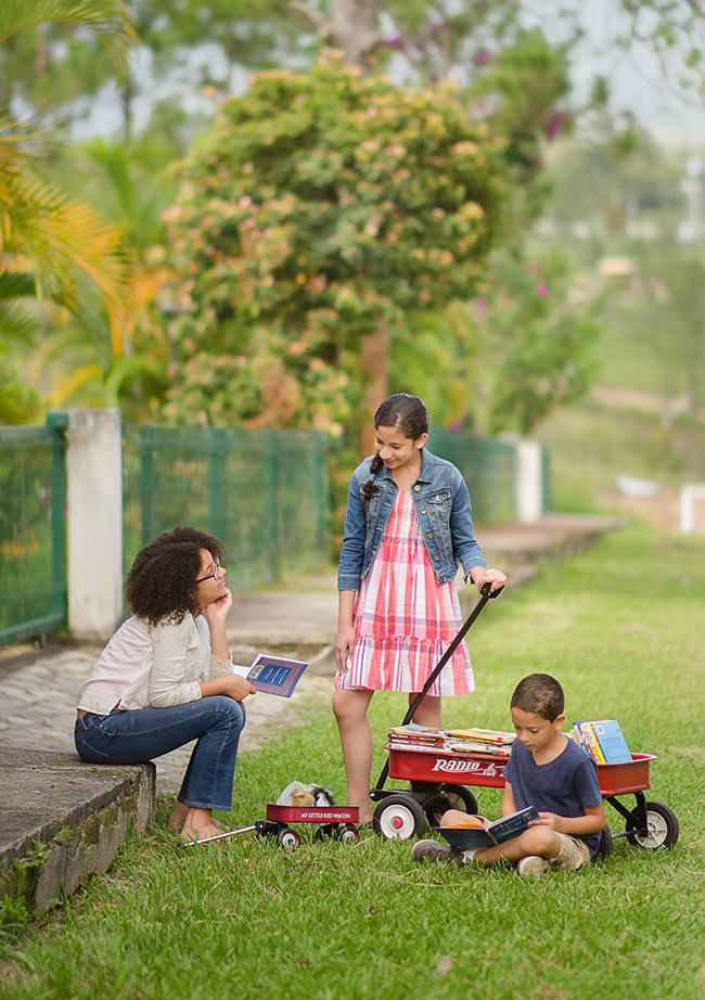 Two sisters with wagons and their brother, photo by the M Family of Siguatepeque, Honduras • 2nd Place Sonlight 2018 catalog cover contest 