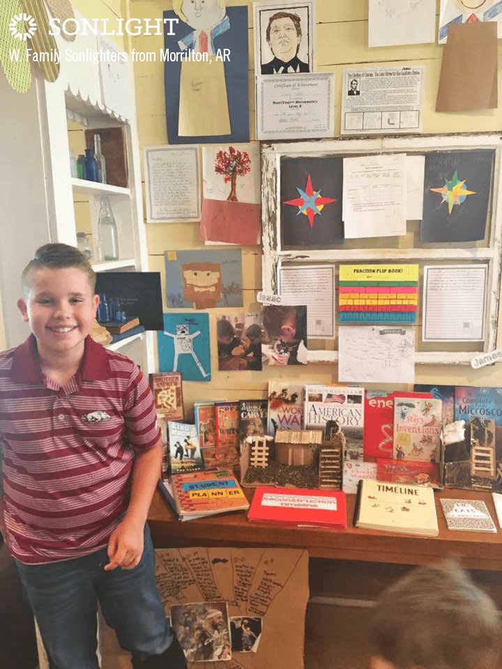 boy smiling while showing his end of the year homeschool showcase