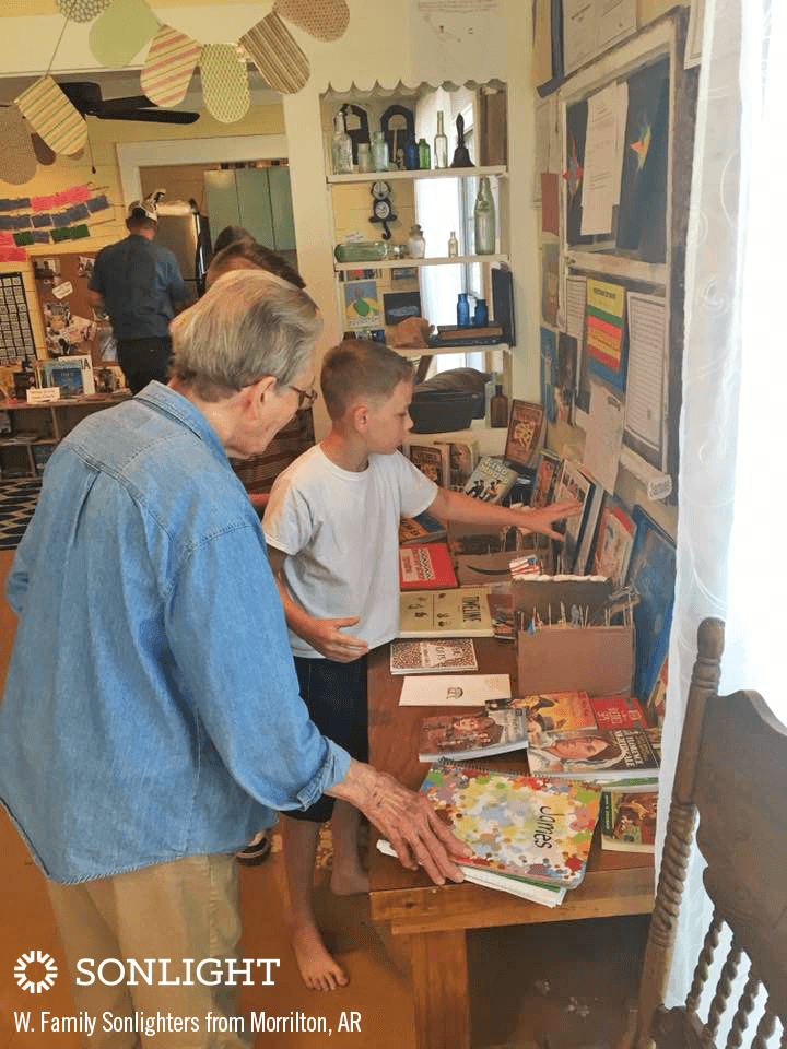 boy showing his grandma his end of the year showcase work