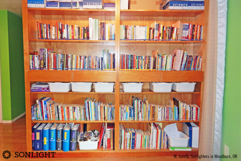 massive bookshelf for years of Sonlight homeschool curriculum