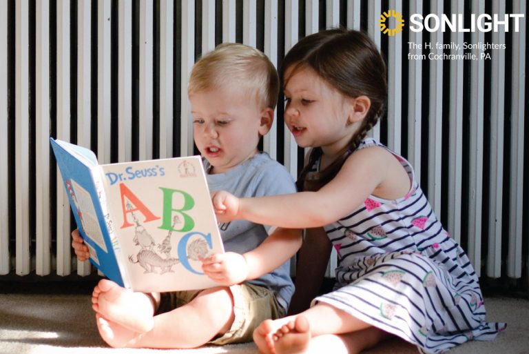 two preschoolers enjoy a book