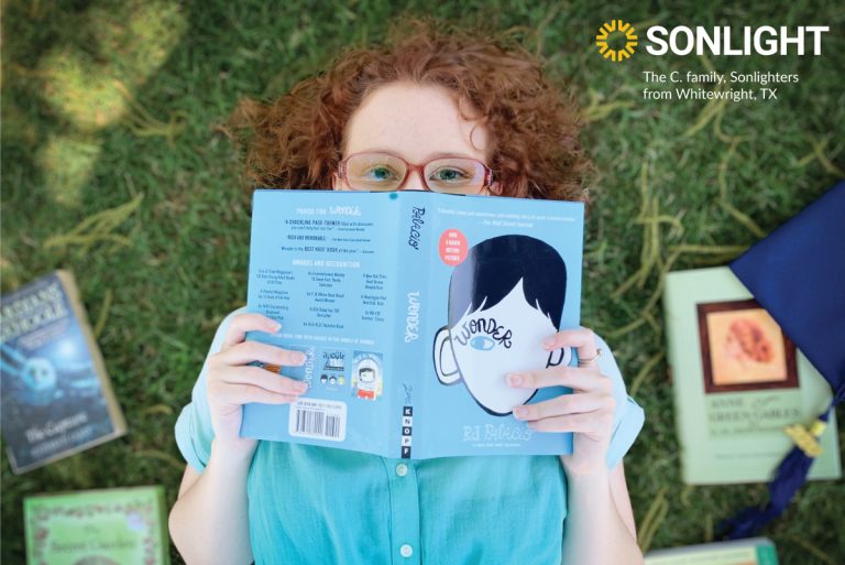 high school senior poses with favorite books