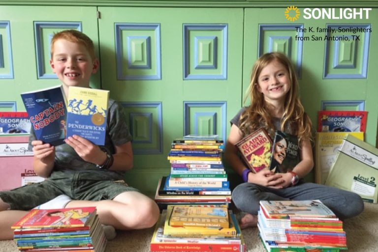 two kids show off their homeschool books