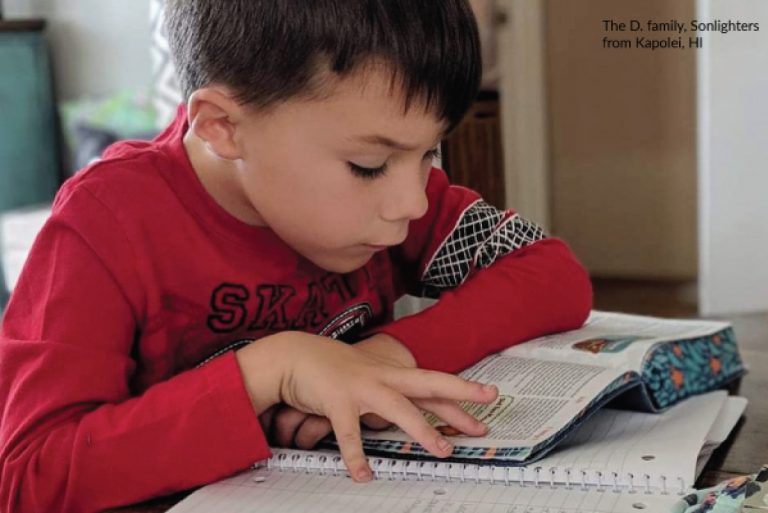 a boy reads a bible passage