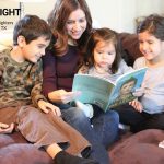 mom reads to three children