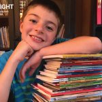 happy Sonlight student poses with his books